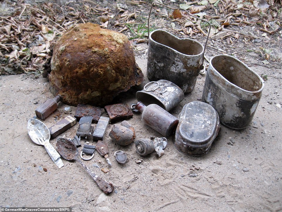 Soldiers' possessions - including a key, spoons and drinking bottle - found in the mass grave, which is being excavated by the German War Graves Commission