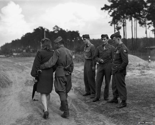 American soldiers observing a Soviet soldier with a woman in Berlin